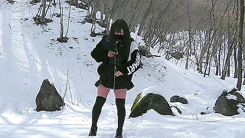 Asian brunette naked outdoors in the snow in the woods